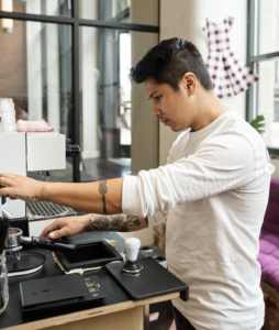 Coffee Tab owner Johnathan Tran making coffee